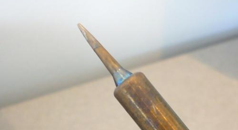 When should I clean my soldering iron tip?